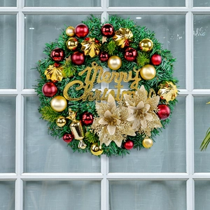 Green Christmas wreath with red and gold balls and Merry Christmas sign on white window