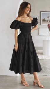 Detail of black off-shoulder tiered dress with puff sleeves and cinched waist design