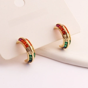 Close-up of C-shaped hoop earrings with multi-color zircons on white jewelry card
