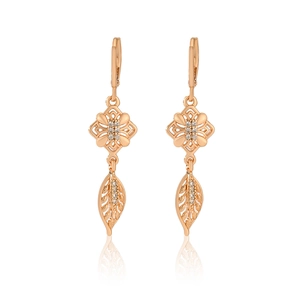 Macro detail of rose gold hollow flower earrings with sparkling cubic zirconia accents