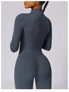 Rear view of a dark grey-blue yoga bodysuit showing compression and lifting effect