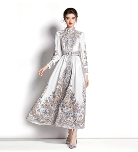 Close-up of lantern sleeves and paisley print detail on a white stand-collar dress