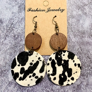 Bohemian western earrings with wood and cowhide animal print on a jewelry display card