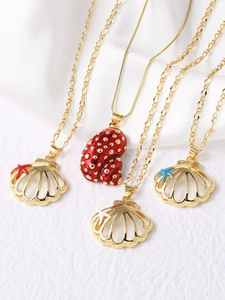 Detailed close-up of gold sea shell and conch pendants with colorful oil drip enamel finish