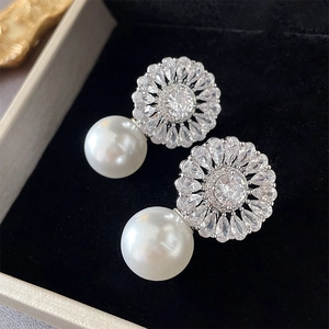 Elegant floral zircon and pearl stud earrings set in a premium jewelry display box