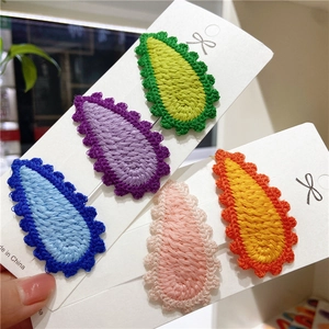 Set of five colorful crochet teardrop hair clips with wavy knit edges on display cards