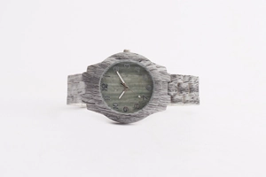 Detail of dark grey wood grain watch dial with clear numeric indices and silver hands