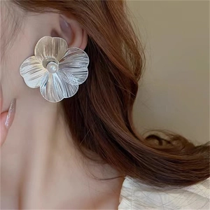 French vintage silver flower earrings with pearl center worn by model for elegant style