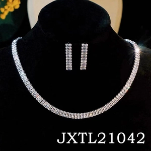 Macro shot of silver bridal necklace and earrings set with emerald-cut cubic zirconia