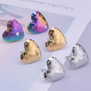 Macro detail of heart-shaped stainless steel charms with mesh texture and small holes