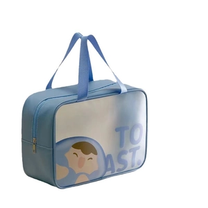 Detail of blue waterproof toiletry bag with zipper, handle, and cute cartoon toast print