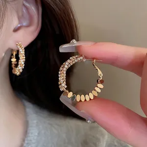 Gold-plated geometric hoop earrings with sparkling cubic zirconia and textured silver pieces