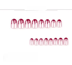 Detail view of pink press-on nails with red French tips and 3D cherry accents