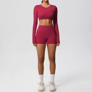Detail of rose red yoga set with thumbhole sleeves and high waist compression shorts
