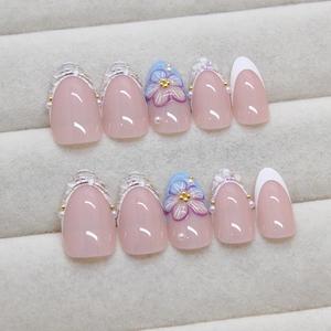 French style nude press-on nails with 3D floral patterns, pearls and gold bead accents