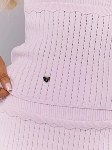 Détail de l'ensemble deux pièces en tricot rose avec texture côtelée et cœurs en métal
