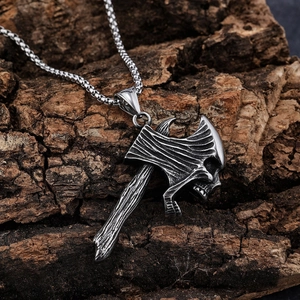 Retro stainless steel axe pendant with skull detail on rustic wood bark background