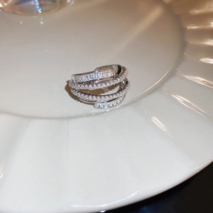 Detail of silver multi-layer crossover ring with sparkling pavé cubic zirconia