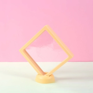 Yellow PE film floating jewelry box with round base on a pink and white background