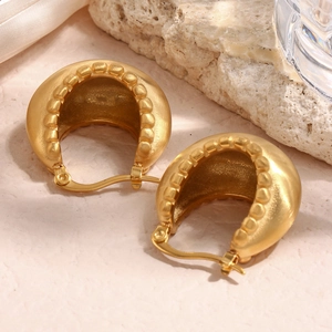 Detailed macro view of 18K gold plated matte brushed ball basket earrings for women