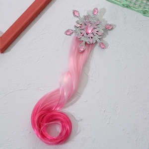 Detail of pink snowflake hair clip with shiny crystals and long curly gradient hairpiece