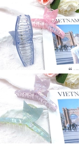 Close-up of matte fishtail hair claws in pastel blue, pink, lilac, and green colors