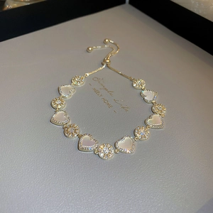 Gold plated heart bracelet featuring white mother of pearl and zircon stones