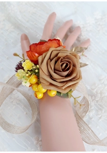 Detail of vintage brown rose wrist corsage with autumn berries and leaf accents