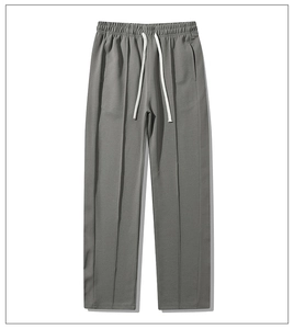 Detail view of men's casual joggers showing elastic drawstring waist and vertical seam pleats