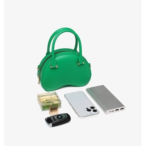 Green PVC jelly handbag with gold zipper and essentials showing large capacity