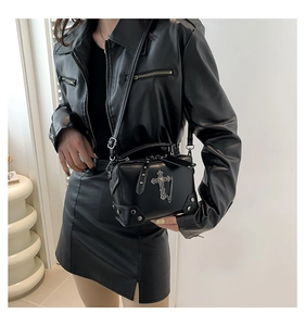Gothic black leather crossbody bag with silver cross and metal chain on a leather model