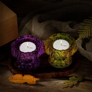 Close-up of purple and amber lotus glass candle holders with floral petal textures