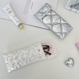 Detailed view of quilted PU bow eyewear pouches with silver and heart stitching