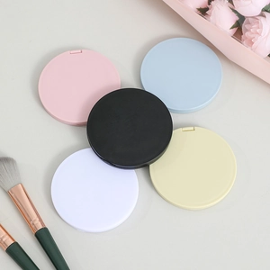 Portable folding round makeup mirrors in multiple pastel colors with a minimalist plastic case