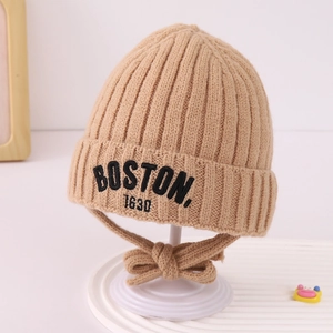 Detailed knit texture of khaki winter hat with Boston embroidery and ear flaps