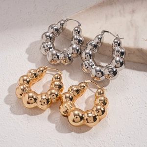 Orecchini a cerchio a bolle in oro e argento lucido su base in marmo bianco