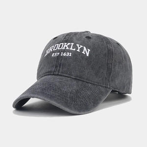 Detail showing white BROOKLYN EST 1631 embroidery on washed dark grey cotton baseball cap