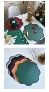 Close-up of irregular wave round faux leather placemats with delicate edge stitching detail