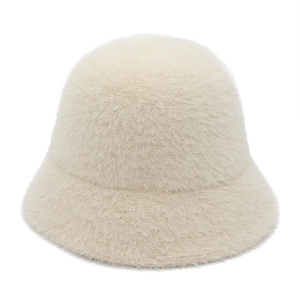 Detailed texture of beige faux mink fur bucket hat with soft plush warm fabric