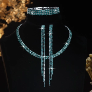 Macro detail of teal rhinestone necklace, three-row tassel earrings and bracelet set