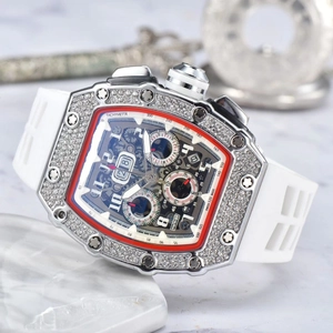 Close-up of luxury tonneau-shaped watch with diamond bezel and white rubber strap