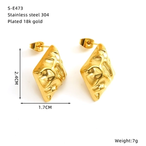 Detail view of 18k gold plated stainless steel rhombic earrings with hammered texture