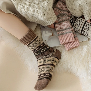 Thick wool winter socks with vintage ethnic jacquard pattern on a cozy fur rug