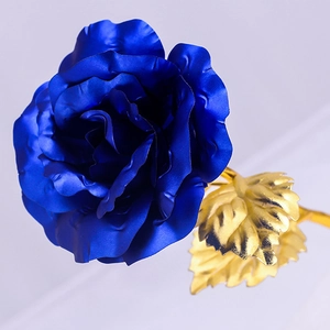 Detailed close-up of dark blue gold foil rose petals with golden metallic stem