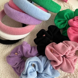 Detailed set of towel fabric headbands and matching scrunchies in various soft candy colors