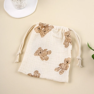Detail of soft muslin cotton drawstring bag with cute brown bear prints for infants