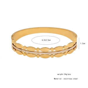 Detail of gold stainless steel double-layer wave bangle with small inlaid diamonds