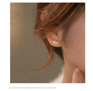 Detail showing elegant s925 silver bow stud earrings with sparkling cubic zirconia stones