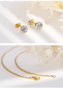 Close-up of gold chain clasp and crystal ball studs from the titanium steel jewelry set
