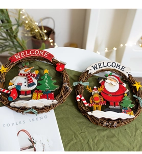 Detail of Christmas rattan wreath with snowman and Santa decorations in a warm home setting